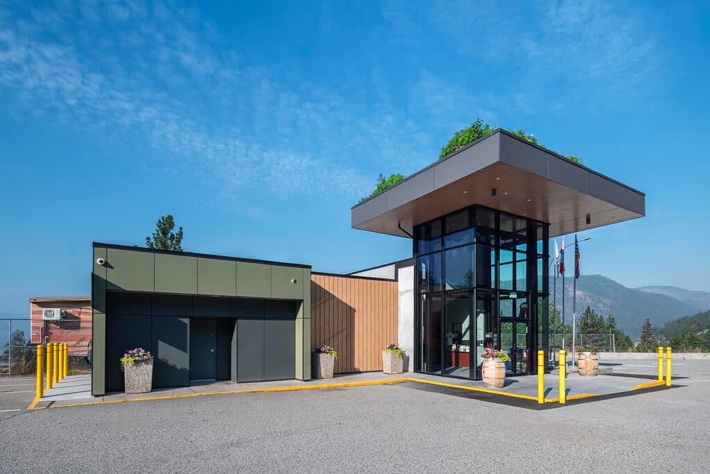 Contemporary visitor center with glass entrance and mountain view.
